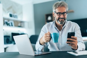 A man working from home using different devices